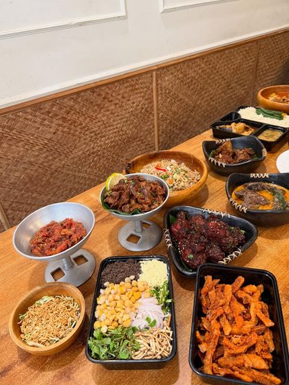 Another angle of our celebratory feast, highlighting dishes like sweet potato fries, a fresh chickpea salad, and various meat preparations in traditional bowls.