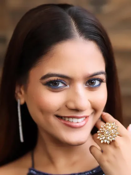 A close-up of this glamorous look, featuring a blue winged liner and a flawless, glass-skin finish. This is perfect for a reception or cocktail event.