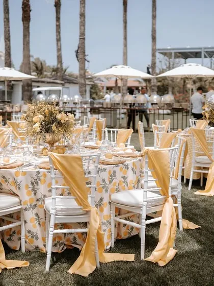 An outdoor luncheon in Antalya with a vibrant yellow theme. The floral tablecloths and matching chair sashes brought a sunny and cheerful elegance to the celebration.