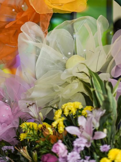 Another detail of the whimsical fabric flowers, showing their soft texture and pastel colors.