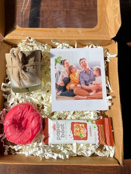 My budget-friendly Diwali gift pack for just ₹250. It includes a scented candle, a donut-shaped soap, a polaroid photo, and a Paper Boat chikki, all packed and shipped anywhere in India.