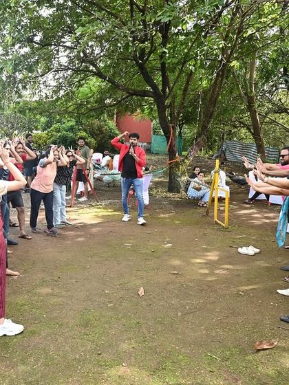 Leading a group warm-up exercise during an outdoor corporate event. I start my team-building sessions by getting everyone synchronized and energized, setting a positive and collaborative tone for the day.
