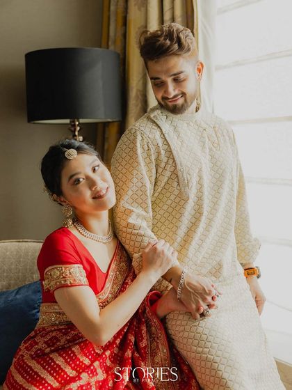 A candid and sweet moment captured by the window. This photo shows the couple's natural interaction and affection, using soft, natural light to create a gentle and romantic scene.