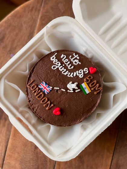 Wish someone well on their new journey with this farewell cake. The design shows a path from India to London, with the message "to new beginnings," perfect for someone moving abroad.