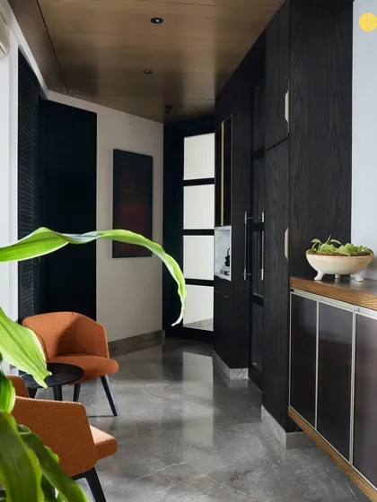 Another shot from the Elle Decor feature, highlighting the home's connection to the bay and its use of a timeless pairing of wood, mirror, and glass.