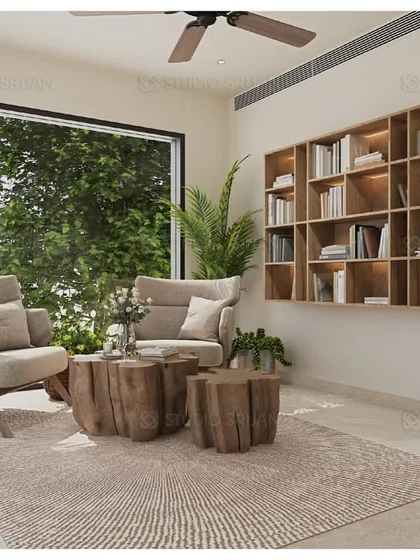 Another view of the reading area, with large windows overlooking lush greenery. The log-style coffee tables continue the natural, organic theme of the space.