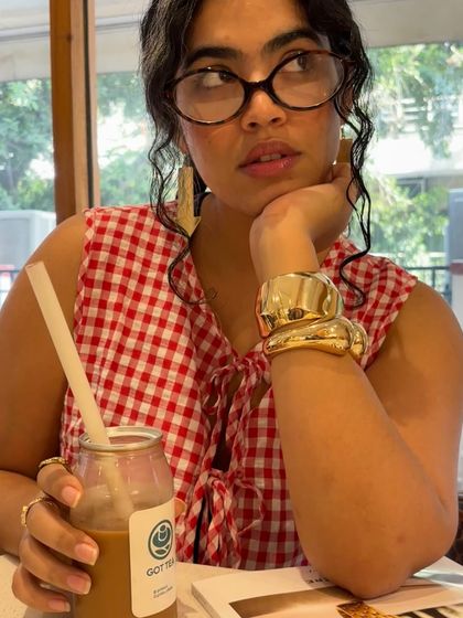 A thoughtful pose, looking up from the magazine. This creates a sense of story and character.