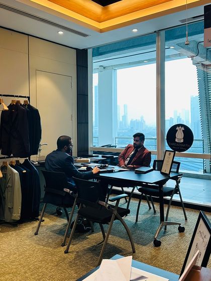 A personal consultation with our founder, Ujjwal Savla, set against the impressive backdrop of a corporate office. This image captures the essence of our service: bringing executive-level styling and bespoke expertise directly to our clients.