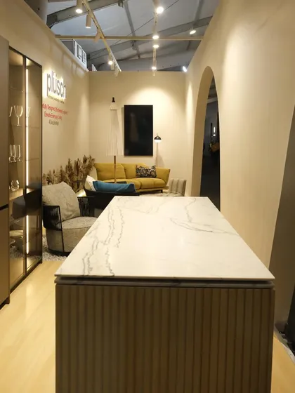 The view from the back of the Plüsch booth, looking through the arches towards the main display kitchen. This perspective shows how the design creates layered views and a sense of discovery.