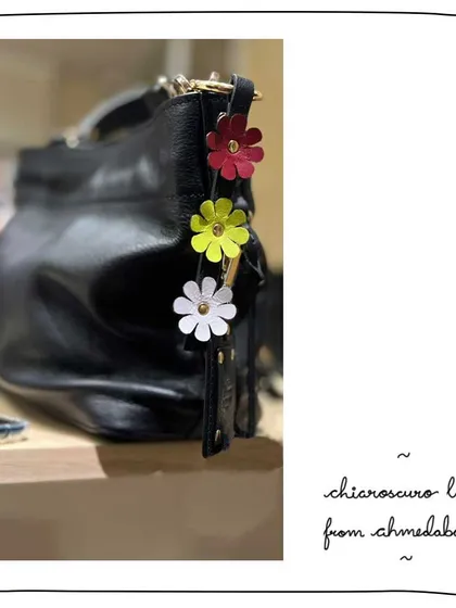 A beautiful collection of flower charms on our patron Kaajal's Little Namrata bag. These small accessories are a great way to add a pop of color and personality.