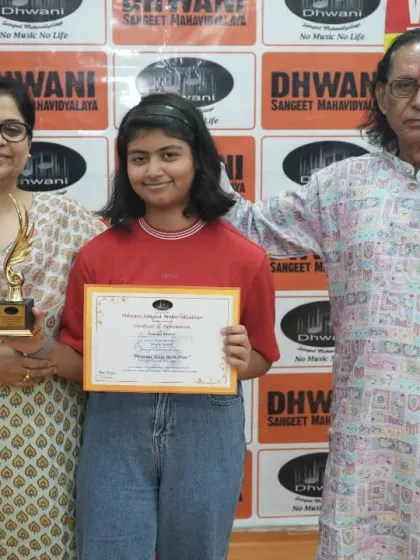 A student with her mother and our senior guru, celebrating her win.