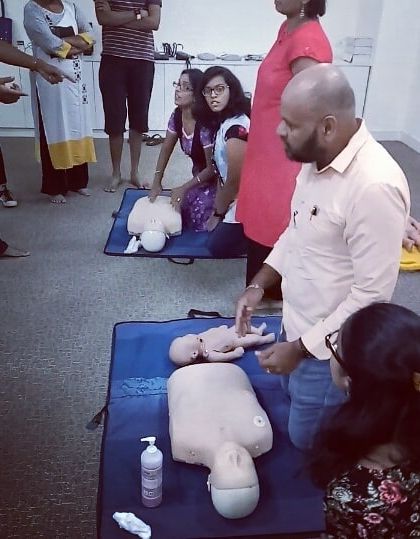 A close-up of the infant CPR demonstration, highlighting the specific techniques required for smaller bodies.