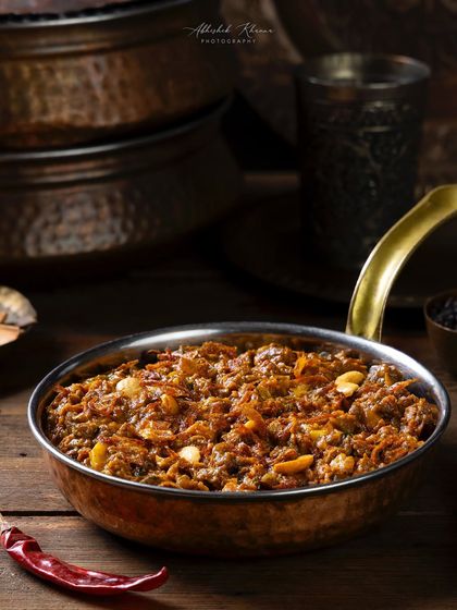 A serving of Keema, or minced meat curry, for The Nawaab's. The focus is on the texture of the dish, captured with precise lighting.