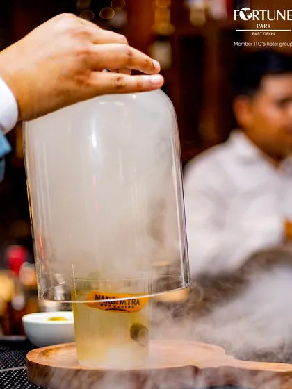 Experience the drama of our signature smoked cocktails at Nakshatra. We believe a drink should be an experience, and this one is designed to delight your senses with its aromatic reveal and complex flavors.