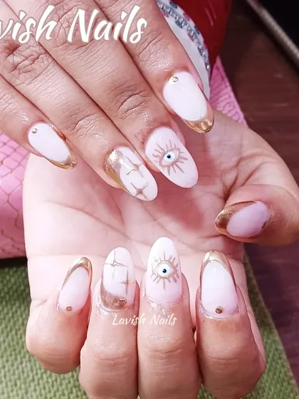 A mystical design with gold chrome French tips and hand-painted evil eye and starburst accents.