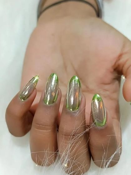 A full view of the green chrome French tip design.