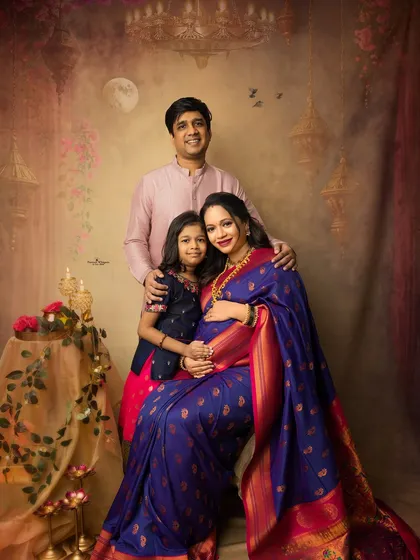 A beautiful family portrait celebrating Diwali and a new life on the way. The family is dressed in festive attire, creating a warm and glowing image of togetherness.