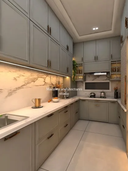 This modern kitchen design combines sleek, grey shaker-style cabinets with a warm marble backsplash and under-cabinet lighting. It’s a perfect example of how I create highly functional yet cozy and inviting cooking spaces.