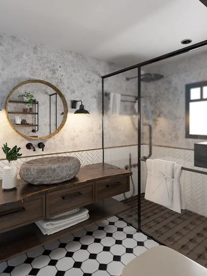Another angle of the earthy bathroom, highlighting the round mirror and industrial-style wall sconces.