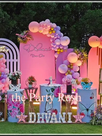 I love creating enchanting outdoor parties, like this butterfly-themed celebration for Dhvani. The setup includes elegant pink backdrops, large butterfly wing props, and a beautiful balloon garland, all designed to complement the natural garden setting and create a dreamy atmosphere.