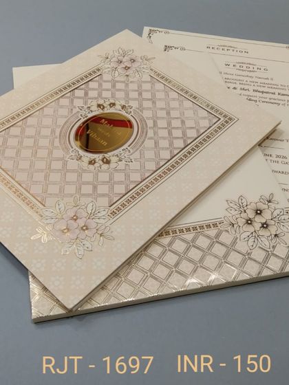 An elegant off-white invitation with a quilted pattern and floral details. The design is sophisticated and perfect for a formal wedding celebration.