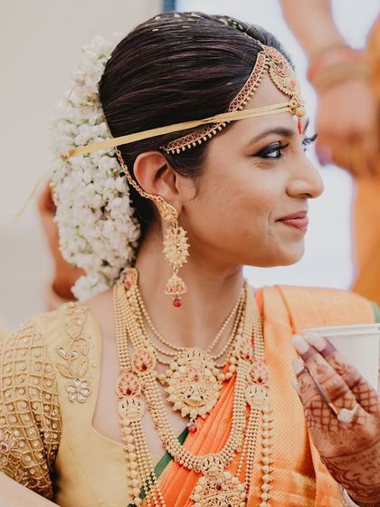 A candid moment of the bride enjoying a quiet cup of chai amidst the wedding hustle. It's these real, unposed shots that tell the true story of the day.