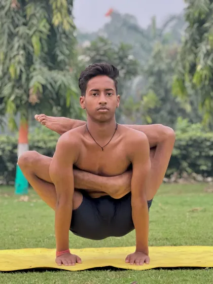 The Omkarasana is a powerful arm balance that also requires significant hip flexibility. Here, my student demonstrates the intense focus needed to hold this pose.