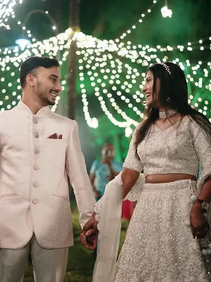 The grand entrance as a married couple. The sparkling lights and their happy expressions make this a magical and celebratory moment, perfectly captured.