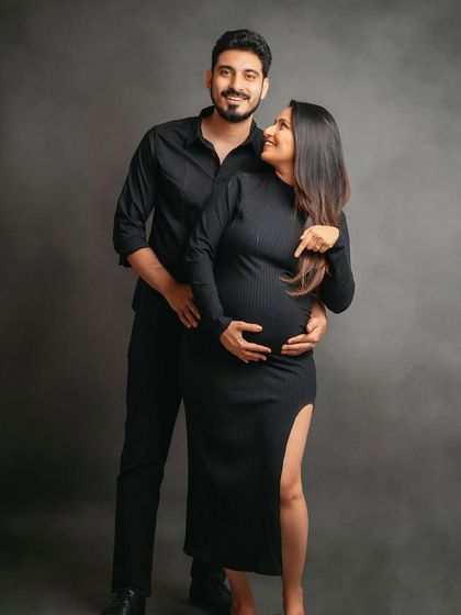 A chic and modern studio maternity portrait with the couple dressed in all black. Their confident smiles and loving gaze make this a powerful image.