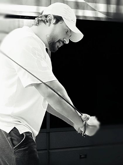 Concentration is key. A black and white shot of me focused during a tricep pushdown exercise.