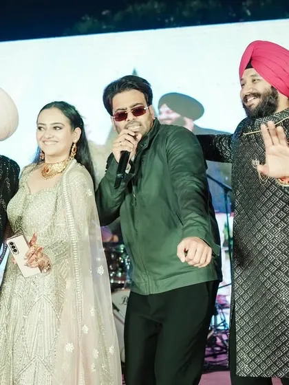 The couple enjoying a live performance by singer Mankirt Aulakh at their wedding celebration.