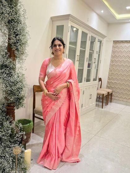 Our client looking lovely in a custom Sacaru blouse, perfectly pairing her pink Kanjeevaram saree with a simple yet elegant design.