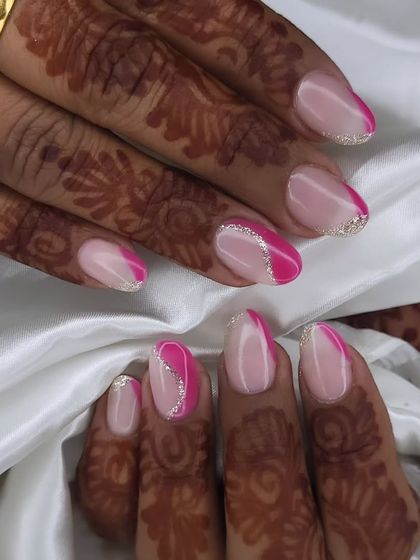 A modern take on bridal nails. This design features a stylish open French manicure with a swirl of pink, accented with a fine line of silver glitter for a touch of sparkle.