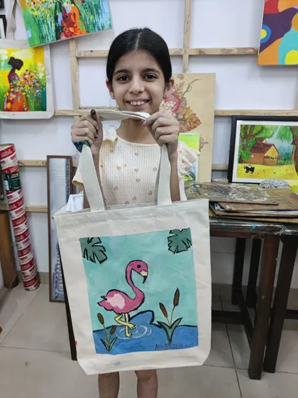 This young artist painted a vibrant flamingo on her tote bag. We provide a variety of designs and full guidance to help every child create a masterpiece.