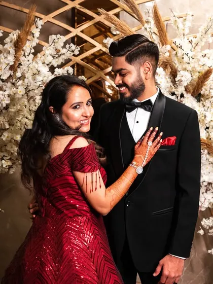 A lovely, interactive portrait. The bride's hand on the groom's chest and their shared gaze create a strong sense of connection.