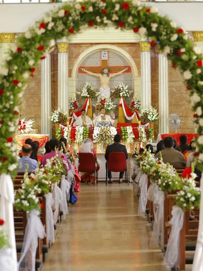 We have experience covering diverse ceremonies. This wide shot captures the serene and grand atmosphere of a Christian wedding ceremony in a beautifully decorated church.
