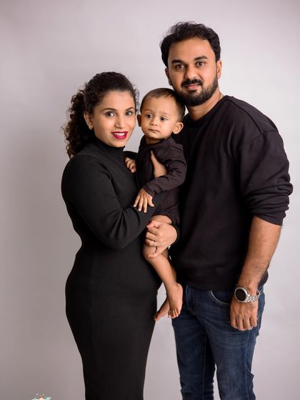 A classic three-person family pose. Holding the baby in the center keeps the connection strong and the composition balanced.