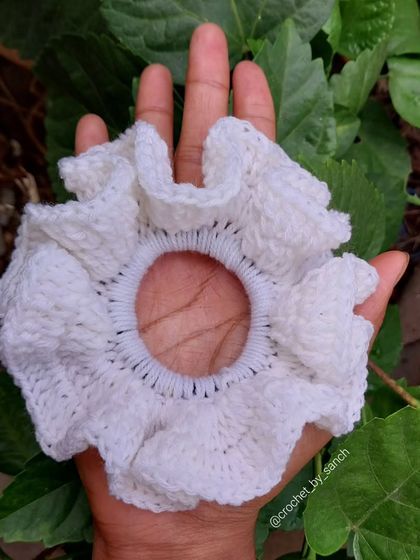 This large, fluffy white crochet scrunchie is super soft and gentle on your hair. It's perfect for a classic, clean look.