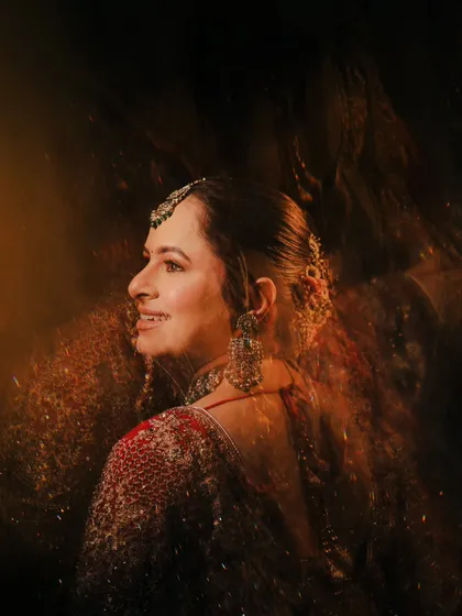 This artistic bridal portrait uses a slow shutter speed to create a beautiful motion blur effect, giving the image a dreamy and vintage feel.