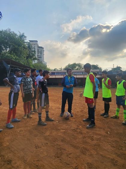 A coach gives a pre-game talk to a youth football team during the HB Sports All Sports Tournament. Strategy and motivation are key parts of our management.