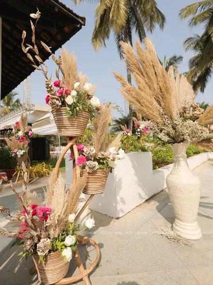 Rustic wicker baskets filled with pink roses and pampas grass, demonstrating our attention to detail in creating beautiful decor elements.