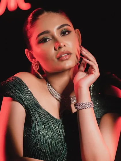 A close-up portrait that captures the confidence this makeup look inspires. The green eyeshadow makes her eyes pop.