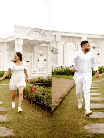Running into their forever. This playful shot captures the couple's excitement and joy during their pre-wedding shoot at a beautiful, classic location.