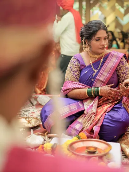 A candid shot during the wedding rituals. The drape is secure and neat, ensuring the bride is comfortable throughout the long ceremony.