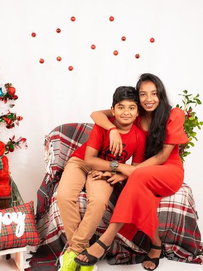 A sweet portrait of a brother and sister from a Christmas mini-session. Their coordinated red outfits and happy smiles capture the holiday spirit.