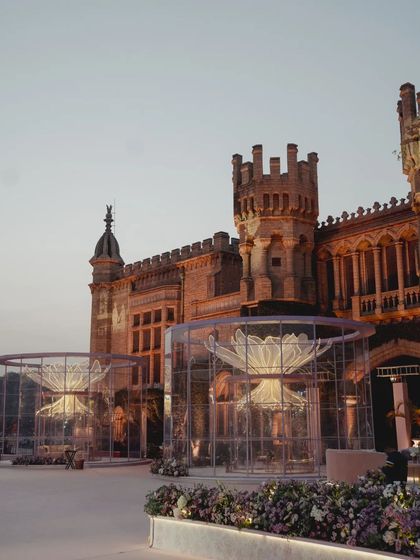 A fairytale reception set against a real castle. We constructed giant, transparent lounges with illuminated flowers inside, creating a modern spectacle that complemented the historic grandeur of the venue.