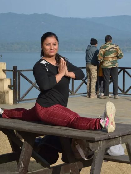 Holding a full split, or Hanumanasana, on a picnic table with a beautiful lake view. I love taking my practice outdoors and finding creative ways to stretch and move.