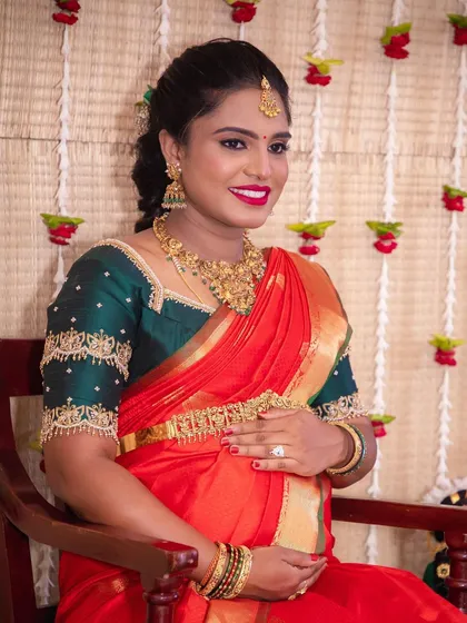 This is one of my favorite looks for a baby shower. I focused on creating flawless, glowing skin and a bright red lip to match the joy of the occasion, making sure she felt as radiant as she looked.