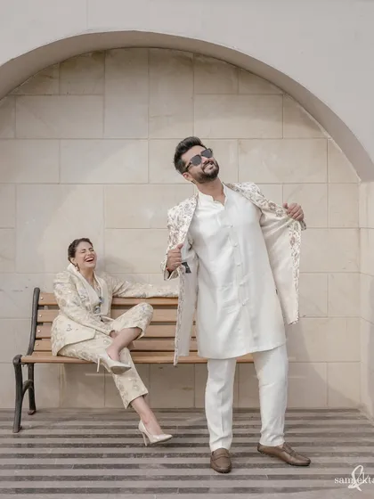 Sanjana and Maahir share a laugh on a bench. This candid portrait captures their easy chemistry and the fun they have together, showing their personalities beyond the formal wedding attire.