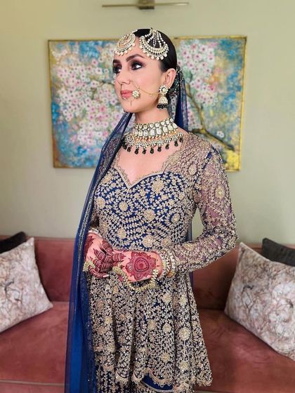 A side view of this beautiful wedding guest in her royal blue sharara. The makeup is flawless and the sleek hair completes the sophisticated look.
